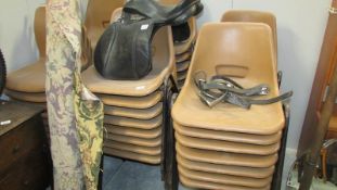 A large quantity of stacking chairs
