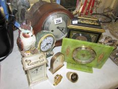 An oak mantel clock and several other clocks