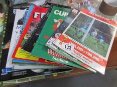 A quantity of football programmes