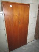 A teak effect 2 door cupboard