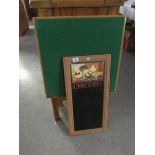 A folding card table and a kitchen chalk board