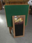 A folding card table and a kitchen chalk board