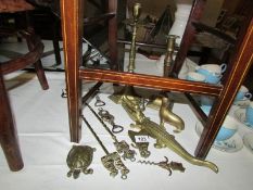 A mixed lot of old brass ware including nut cracker, candlesticks,