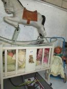 A wooden dolls cot with dolls,