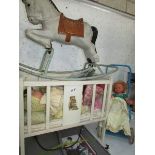 A wooden dolls cot with dolls,