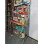 A wrought iron shelving unit with wooden shelves
