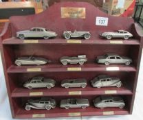A collection of pewter Jaguars on rack
