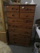 A tall pine chest of drawers
