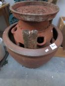 A large pottery garden pot and an earthenware planter