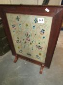 An embroidered fire screen