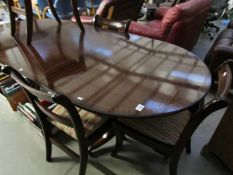 A mahogany extending dining table and 4 chairs