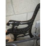 A pair of cast metal bench ends