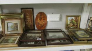 A shelf of framed and glazed prints