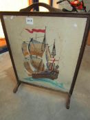 A fire screen with ship emboridery