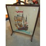 A fire screen with ship emboridery