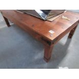 A large heavy wood coffee table