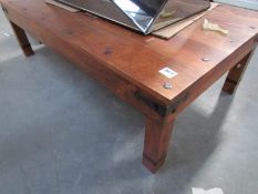A large heavy wood coffee table