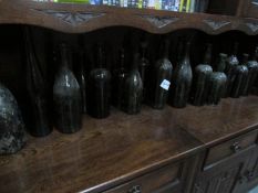 A quantity of old dark glass bottles