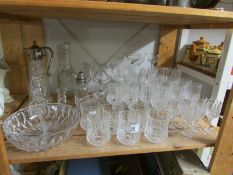 A shelf of assorted glass ware