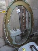 A gilt framed oval mirror