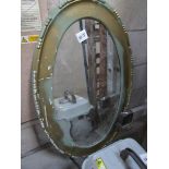 A gilt framed oval mirror