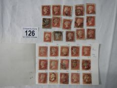 Stamps - A booklet containing over 100 Victorian British Penny Red stamps and a packet of over 50