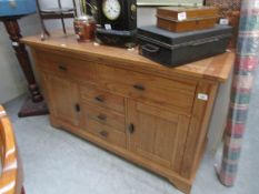 A modern solid oak sideboard