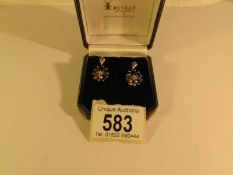 A pair of earrings set with amethysts, citrine, garnet etc,