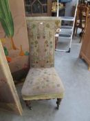 A Victorian prayer chair with tapestry upholstery