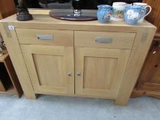 A modern light oak sideboard