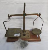 A set of postal scales with weights (one weight missing)