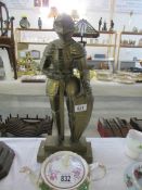 A large heavy brass knight in armour poker stand