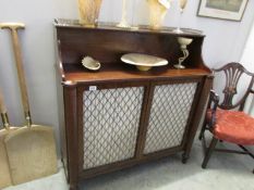 A Victorian mahogany chiffioniere with brass grills in doors