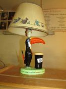 An original Guinness toucan table lamp with original shade