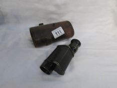 A brass monocular in leather case