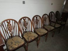 A set of 6 wheel back dining chairs