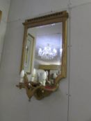 A gilt framed mirror with lights