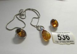 A pair of silver and amber earrings together with a silver and amber pendant on silver chain