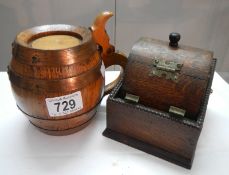 An oak and copper band tobacco jar in the shape of a barrel and an oak cigarette dispenser