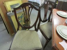 A set of 4 mahogany shield back dining chairs