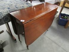 A mahogany drop leaf table