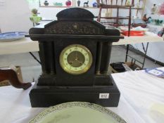 A 19th century heavy black mantel clock