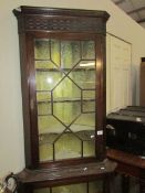 A mahogany astral glazed corner cabinet