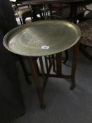 A brass topped folding table