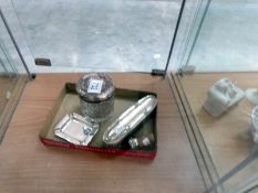 A silver ashtray, a silver topped pot,