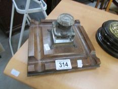 An oak desk stand with glass inkwell