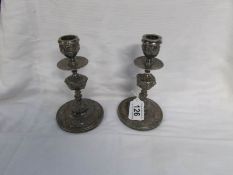 A pair of silver plated candlesticks by Elkington & Co.