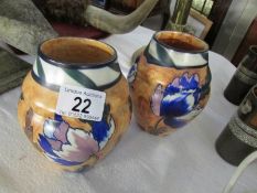 A pair of hand painted arts and crafts vases,