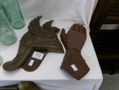 A Roman helmet wall plaque and a glove wall plaque