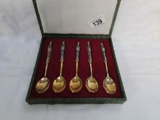 A cased set of Chinese spoons with cloissonne' handles